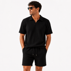 Black ribbed short sleeve polo shirt and matching shorts, front view.