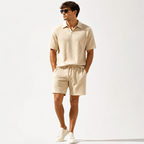 Cream textured short sleeve polo shirt and matching shorts, full front view.