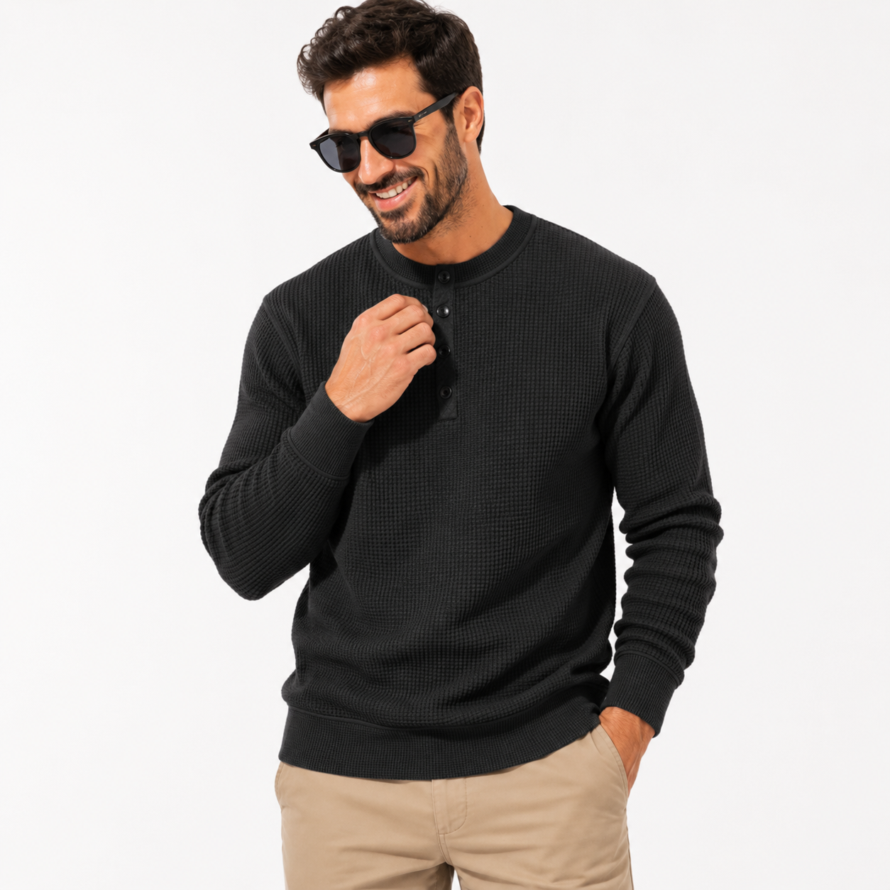 Man wearing a black sweater and sunglasses on a white background