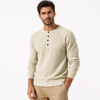 Man wearing a beige long-sleeve shirt with buttons on a white background