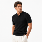 Man wearing a black ribbed knit polo shirt on a white background