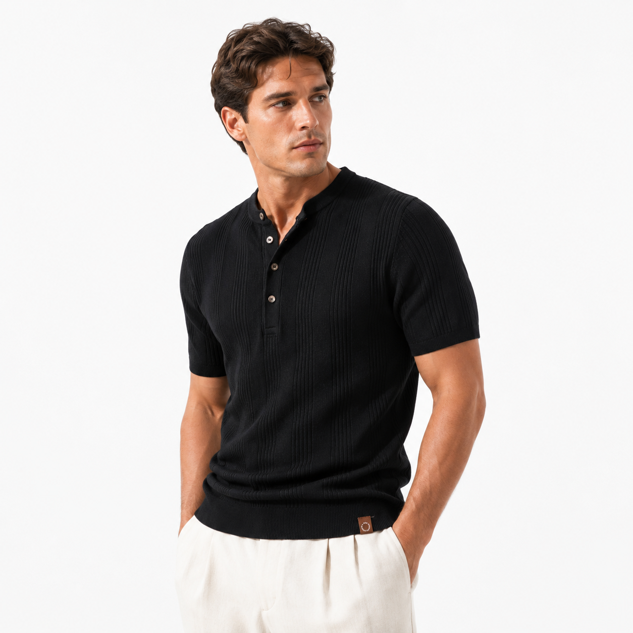 Man wearing a black ribbed knit polo shirt on a white background