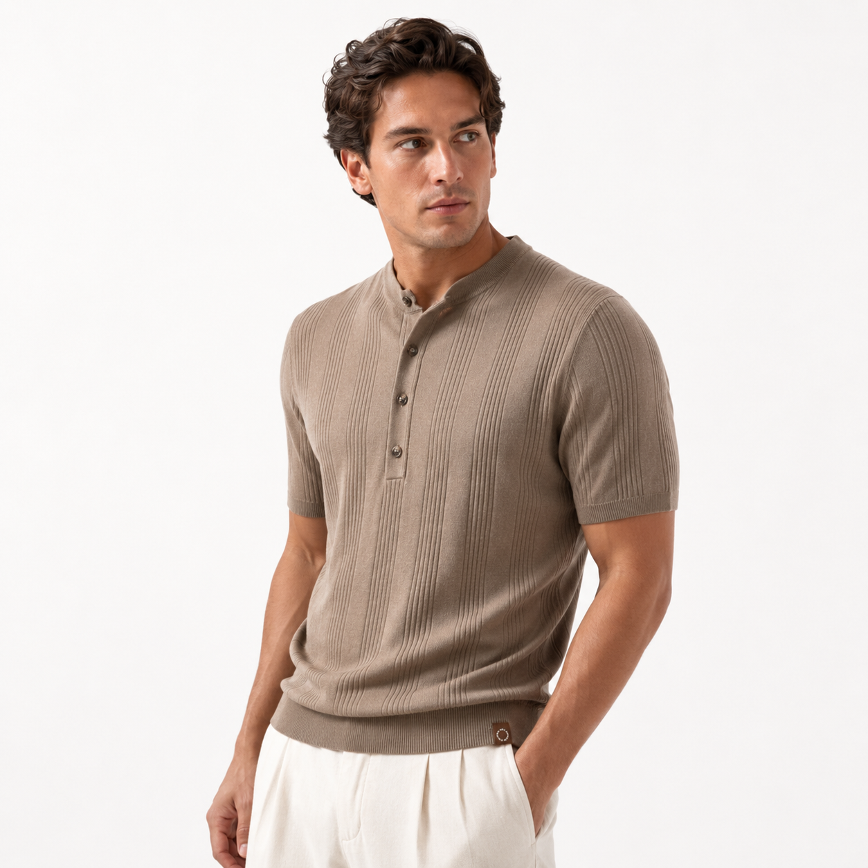 Man wearing a beige ribbed short-sleeve shirt on a white background
