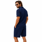 Navy textured short sleeve polo shirt and matching shorts, back view.